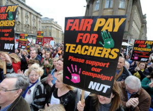 teachers' strike, with placard "Fair pay for teachers - NUT"