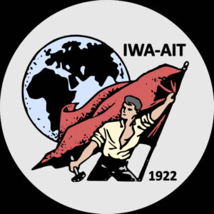 IWA-AIT logo showing a white man standing in front of the globe, carrying a flag in one hand and a hammer in the other