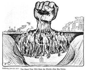 many industrial workers raising their fists, which combine into one giant raised fist
